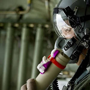 U. S. Air Force member prepares to throw a wind sonde out a C-130J Hercules