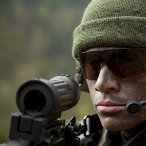 U. S. special forces soldier stays alert while wearing a radio headset during combat