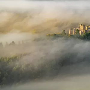 Aerial view of Lennox Castle engulfed in fog during a morning inversion, Lennoxtown, East Dunbartonshire, Scotland. October, 2020