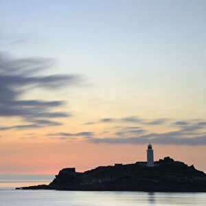 Godrevy Lighthouse at sunset, nr Hayle, Cornwall, UK. June 2009