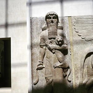 Assyrian sculpture of a man holding a lion, Khorsabad, c8th century BC