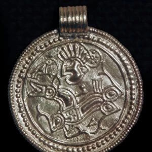 Gold bracteate from Sweden showing Odin and a raven