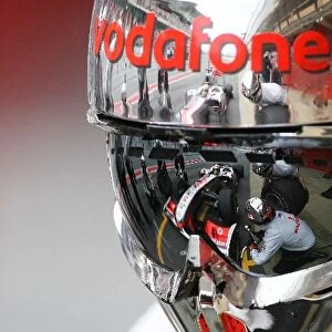 Formula One World Championship: A reflection of Lewis Hamilton McLaren MP4 / 25 in a mechanics helmet