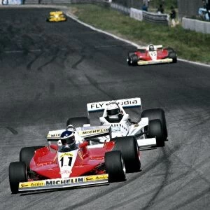 Formula One World Championship: Tenth placed Carlos Reutemann Ferrari 312T3 leads Alan Jones Williams FW06, who retired from the race on lap