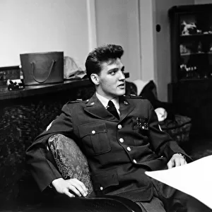 American rock and roll singer and musician Elvis Presley pictured wearing army uniform