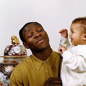Chris Eubank boxer holding his baby in his arms