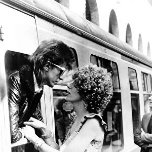 David Bowie leaning out of a railway carriage of the Paris boat train at Victoria station