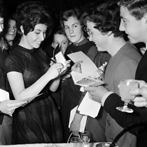 Helen Shapiro signing autographs for newsboys and girls at the Daily Mirror
