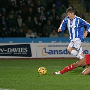 Alex Revell is fouled by Gavin Caines to win a last-minute penalty